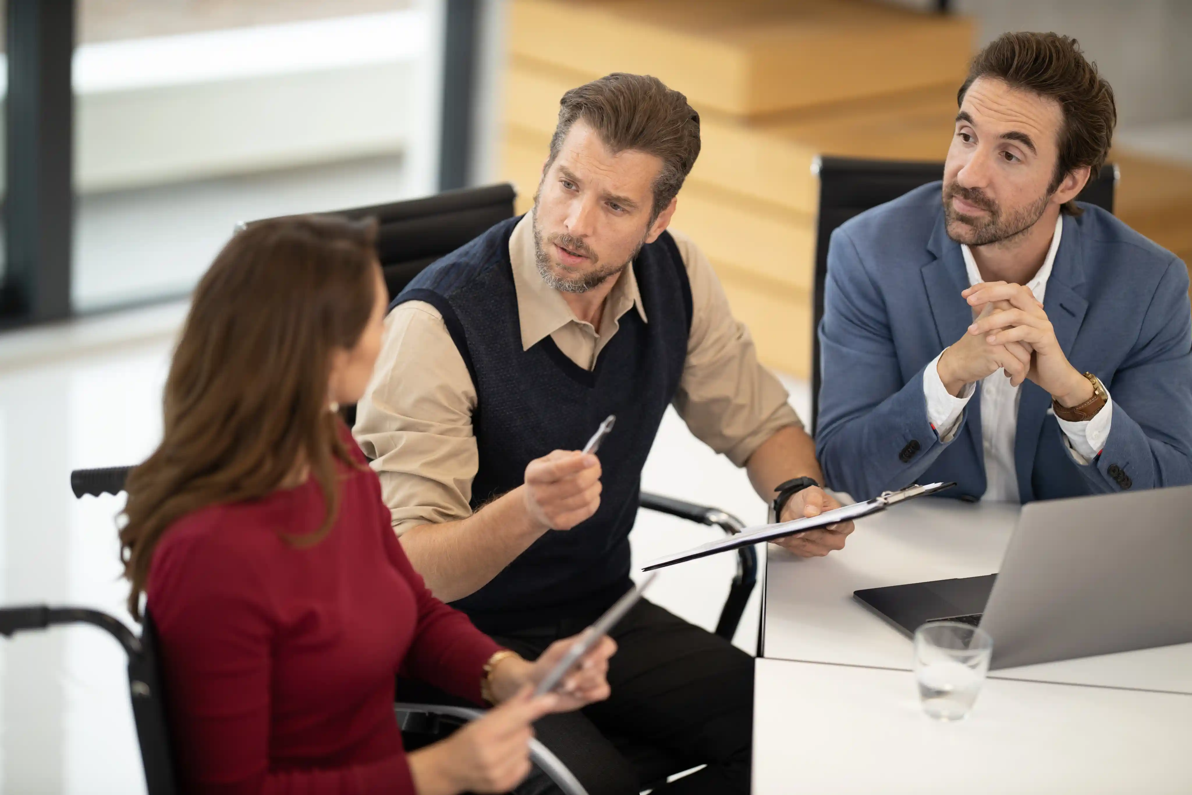 People discussing paperwork together at a table